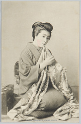 A JAPANESE HOUSEWIFE SEWING CLOTH. image