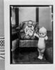 椅子に座る幼児と大きなキューピー人形/Infant in Chair and Large Kewpie Doll image