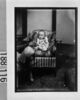 椅子に座る幼児と大きな犬のおもちゃ/Infant in Chair and Large Toy Dog image